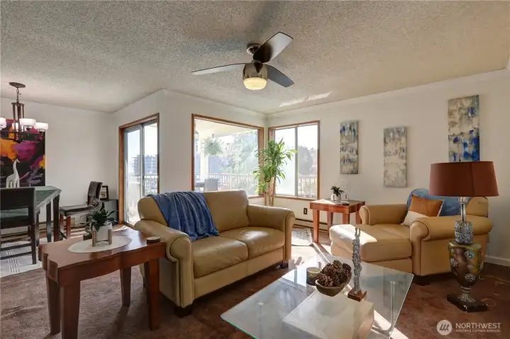 The living room adjoins the dining area. Sliders out to the deck.