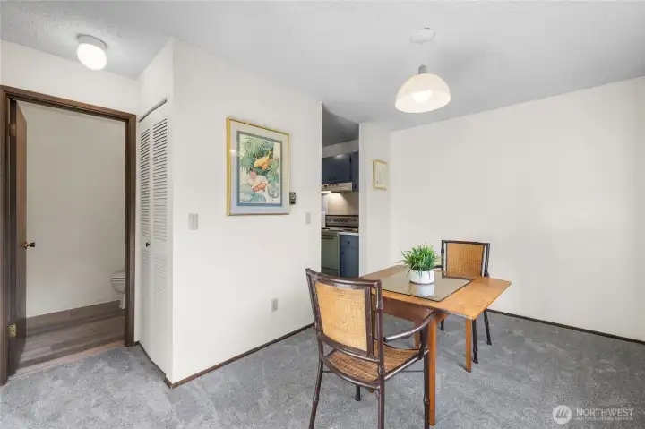 Dining area just off the entry, with access to the half bath on the left and kitchen entry on the right.