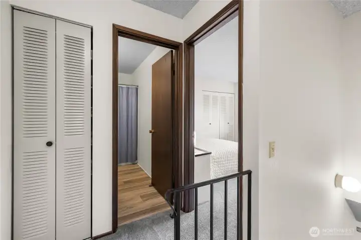 At the top of the stairs is another storage closet, full bath, and primary bedroom.