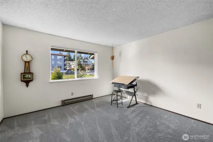 Upstairs second bedroom with large window and new carpet.