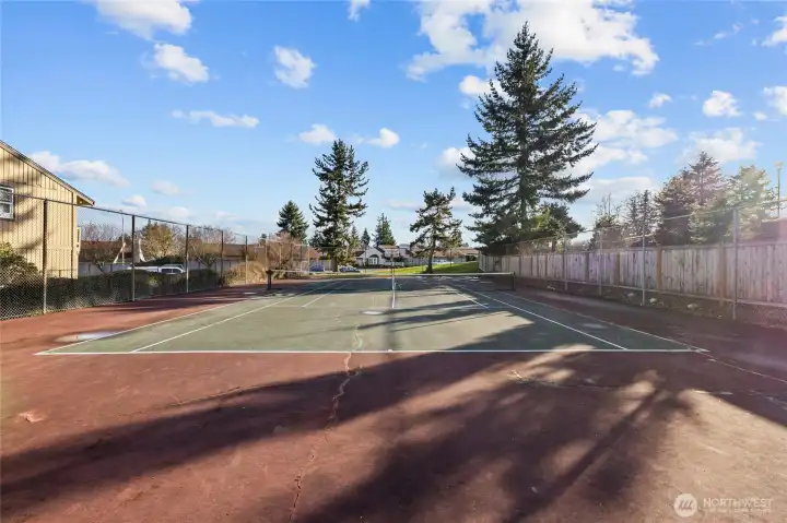 Residents only sport court with space for tennis, basketball, and play.