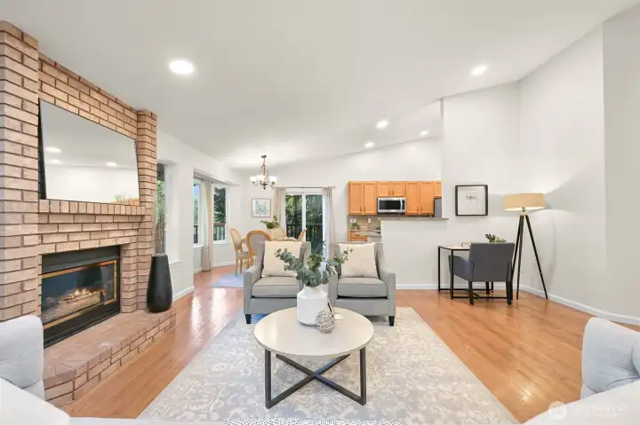 The open living room centers around the cozy fireplace.