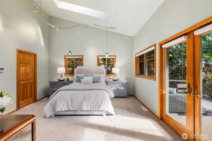 High ceilings and skylights add extra light and depth to this master bedroom