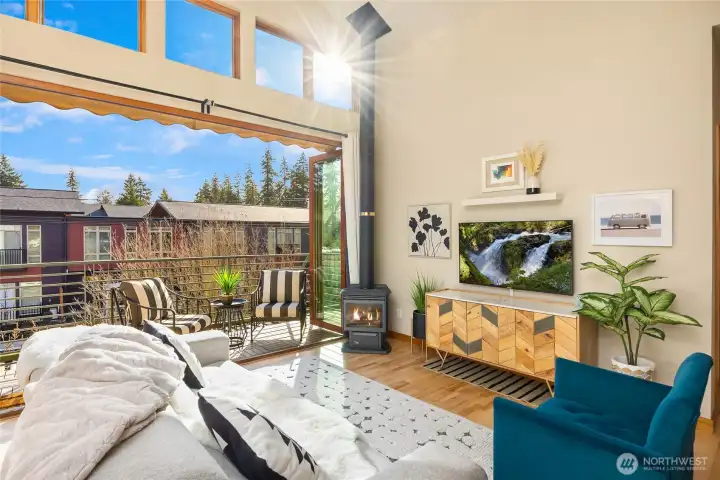 Living space with sliders open to balcony