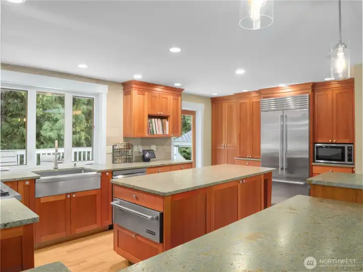 The chef’s kitchen is equipped with premium appliances including Wolf, Sub-Zero, and Bosch, paired with striking leathered granite surfaces.