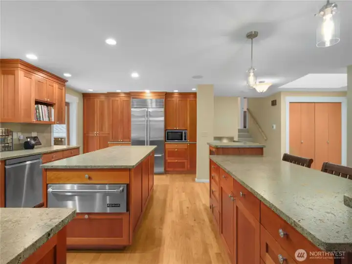 The kitchen features ample built-in storage and a large skylight that fills the space with natural light, creating an airy and inviting atmosphere perfect for cooking and entertaining.