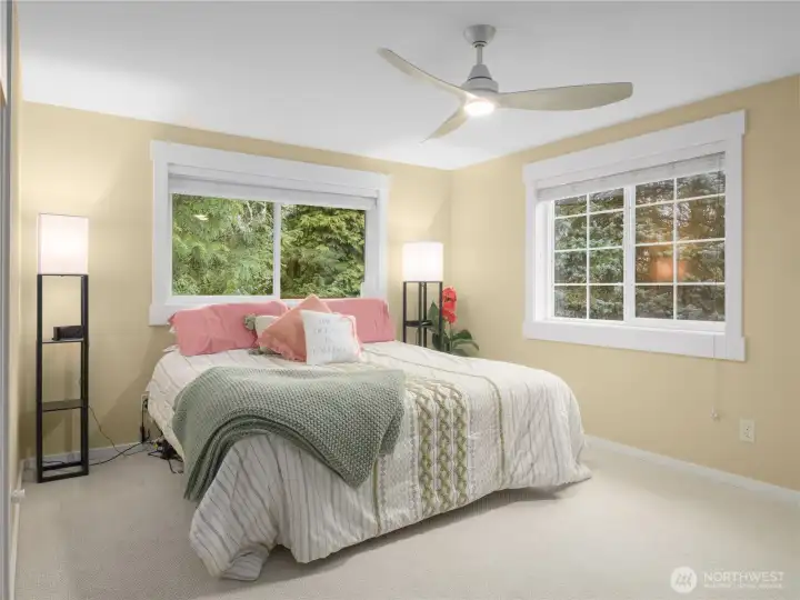 Experience luxury in the secondary primary bedroom featuring a massive closet, a relaxing jet tub, heated floors for ultimate comfort, and a ceiling fan for a cool breeze. Perfect for unwinding and enjoying a spacious, elegant retreat.
