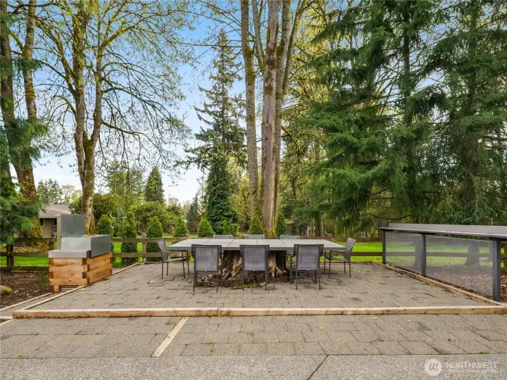 Create the perfect outdoor entertaining area with a giant built-in table, spacious counter, and a cozy fire pit/BBQ for unforgettable gatherings.