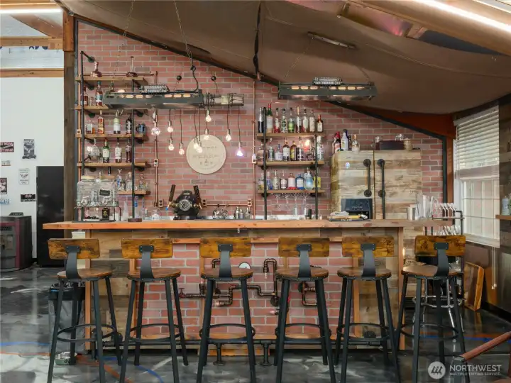 A custom-built bar with a 3-tap beer system offers a personalized space for serving draft beer. It features three taps for variety, perfect for entertaining guests or enjoying a night in. Don't miss the large shelved storage area behind bar area.