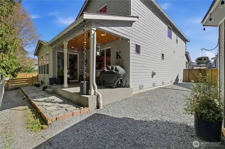 Low maintenance backyard with covered patio over looks the lush green belt