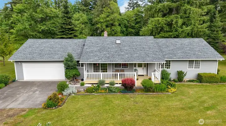 Front elevation, two car garage, front porch with white pickets, and windowed door with sidelights.
