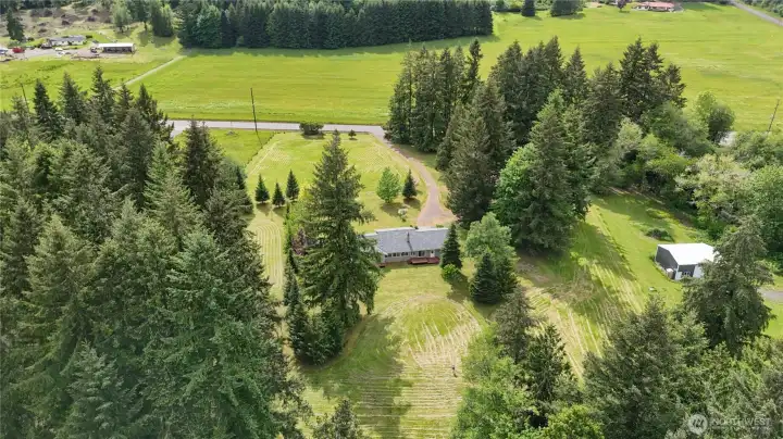 You will see the fence line that divides the property with the whit roofed pole building from the subject property on one side and a definitive fence line on the other side. A quiet rural street runs in front of the property.