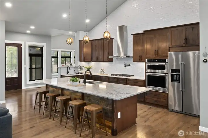Custom cabinetry, quartz counters, stainless appliances, and a statement island create a kitchen that is equal parts functional and beautiful. Custom cabinetry, quartz counters, stainless appliances, and a statement island create a kitchen that is equal parts functional and beautiful.