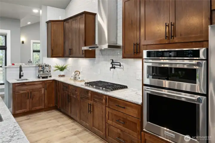Chef’s kitchen with custom cabinetry, premium appliances, dedicated espresso machine station with water and waste connections, pot filler & two kitchen sinks. Chef’s kitchen with custom cabinetry, premium appliances, dedicated espresso machine station with water and waste connections, pot filler & two kitchen sinks.