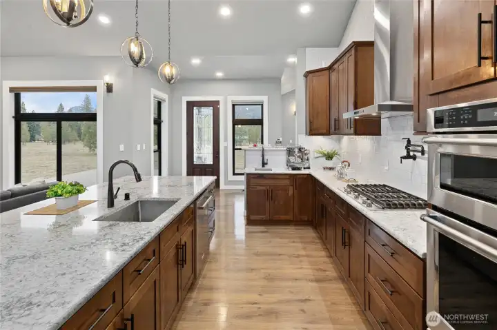 Cook and entertain while enjoying natural light and beautiful mountain property views. Cook and entertain while enjoying natural light and beautiful mountain property views.