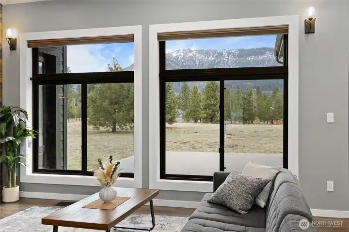 Large picture windows bring the outdoors in, filling the home with natural light and showcasing peaceful mountain views. Large picture windows bring the outdoors in, filling the home with natural light and showcasing peaceful mountain views.