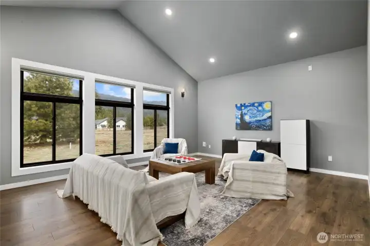 Flexible bonus/media room with vaulted ceilings, expansive windows, and endless possibilities for entertaining, gaming, fitness, or additional guest space. Flexible bonus/media room with vaulted ceilings, expansive windows, and endless possibilities for entertaining, gaming, fitness, or additional guest space.