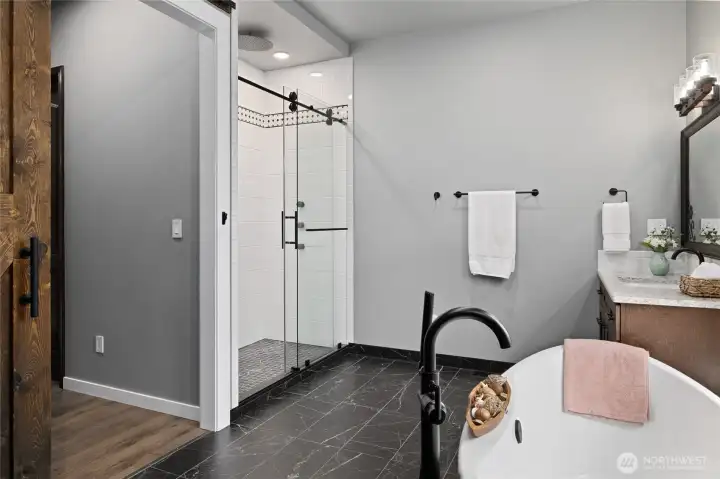 Designed for relaxation, the primary bath features dual vanities, upscale finishes, and a spacious walk-in shower. Designed for relaxation, the primary bath features dual vanities, upscale finishes, and a spacious walk-in shower.