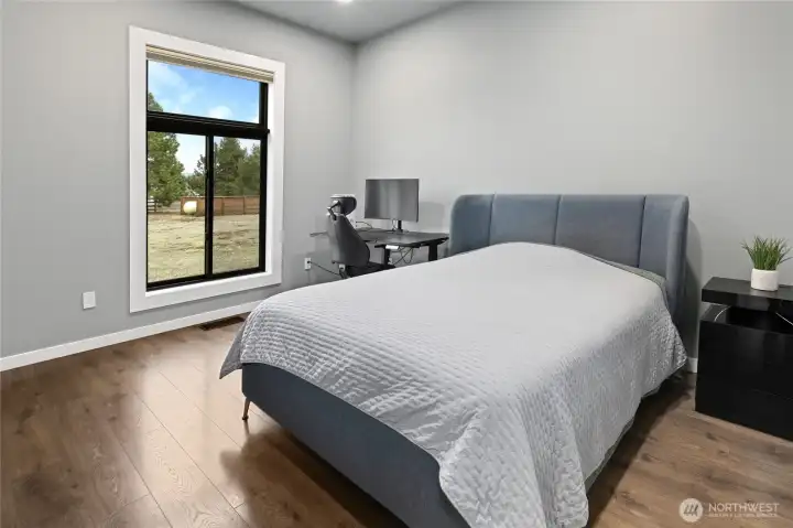 The first of three additional bedrooms. All are large rooms with oversized windows and peaceful property views. The first of three additional bedrooms. All are large rooms with oversized windows and peaceful property views.