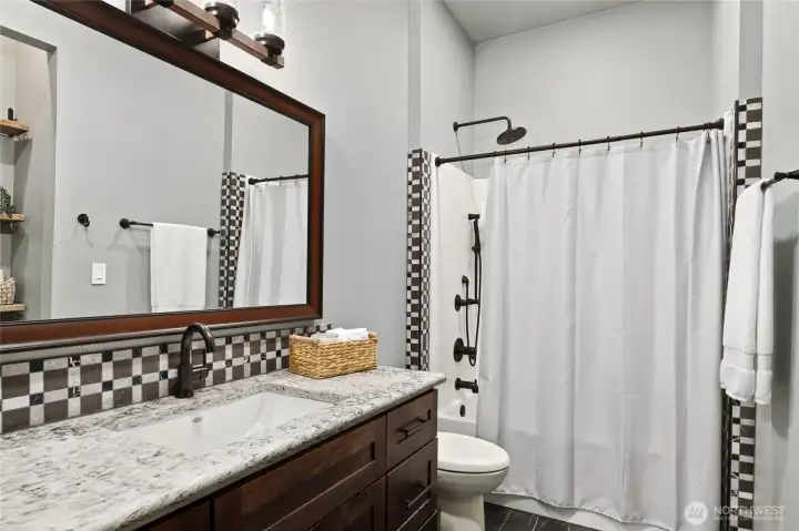 Additional full bathroom with high end Delta shower valve featuring temperature & volume control, comfort, functionality, and designer-inspired finishes for guests and family. Additional full bathroom with high end Delta shower valve featuring temperature & volume control, comfort, functionality, and designer-inspired finishes for guests and family.