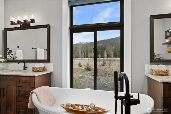 Soak in the freestanding tub while taking in serene mountain and forest views from the luxurious spa-inspired primary bath. Soak in the freestanding tub while taking in serene mountain and forest views from the luxurious spa-inspired primary bath.