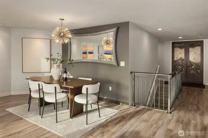 The dining area offers the perfect place for formal gatherings small or large. The mirror on the wall was positioned purposely to reflect the water and natural scenery.
