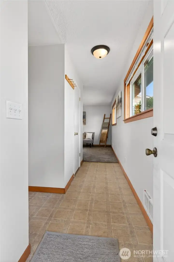 Step into a hall leading to the livingroom or to the kitchen