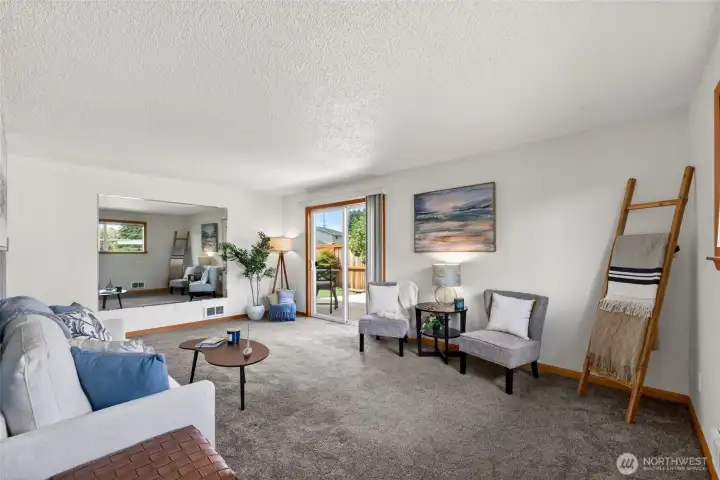 The livingroom is spacious, light and bright, with freshly cleaned rugs and a slider to your deck/patio