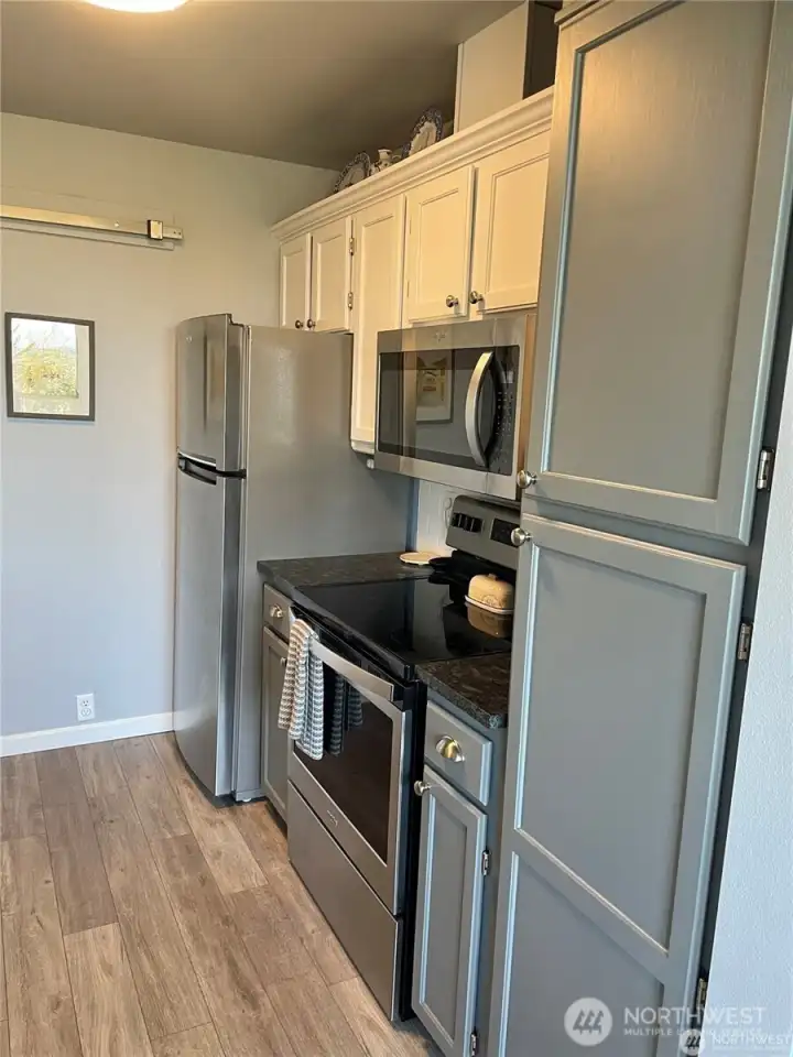 The opposite side of the kitchen showing the nice cabinets and stainless appliances