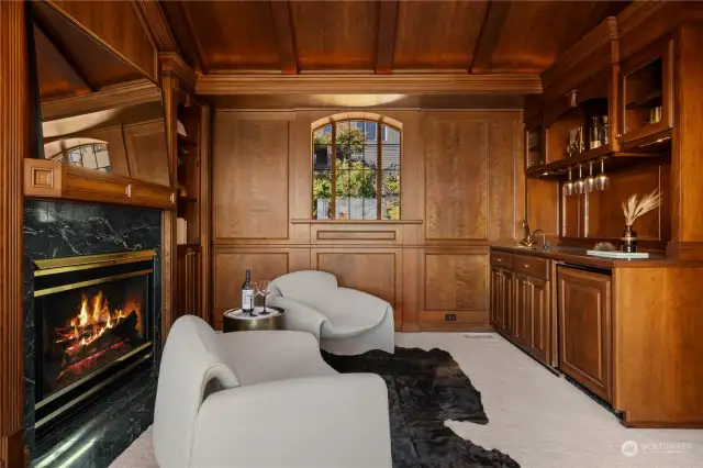 Large office with a wet bar and gas fireplace.