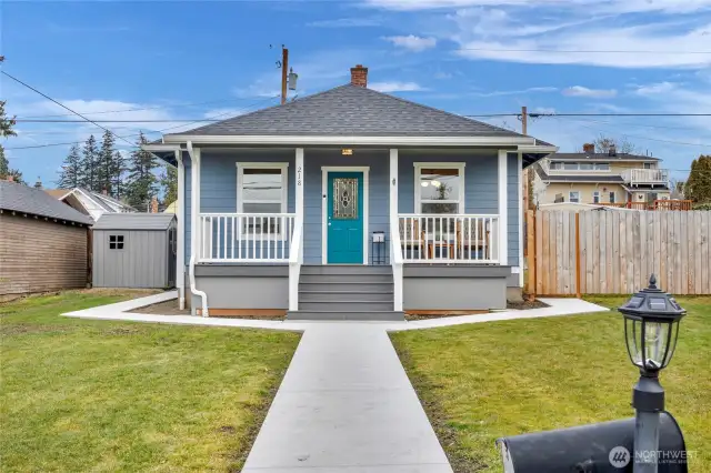 Front walkway with updated pavement running along both sides of home