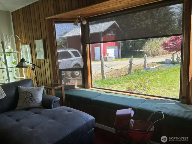 Living room with auto blind part way down plus a window seat