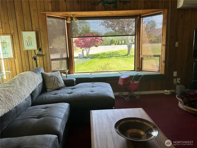 Living room with auto blind part way down