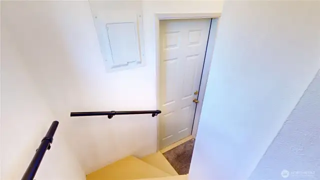 Stairs leading to the back door and basement from the kitchen nook