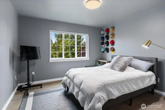 Bedroom #2 faces West with LVP flooring, custom light fixture, custom closet, and room darkening blinds.