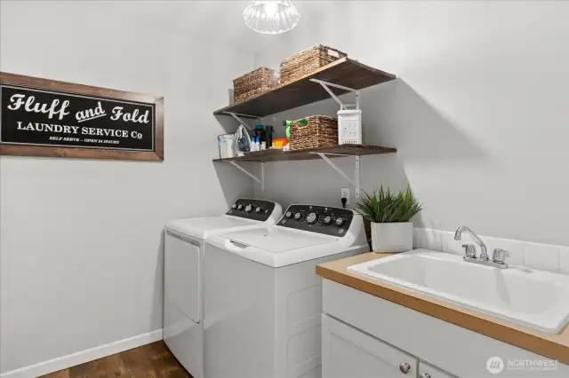 Laundry Room Upstairs with a Utility Sink and brand new washer and dryer.