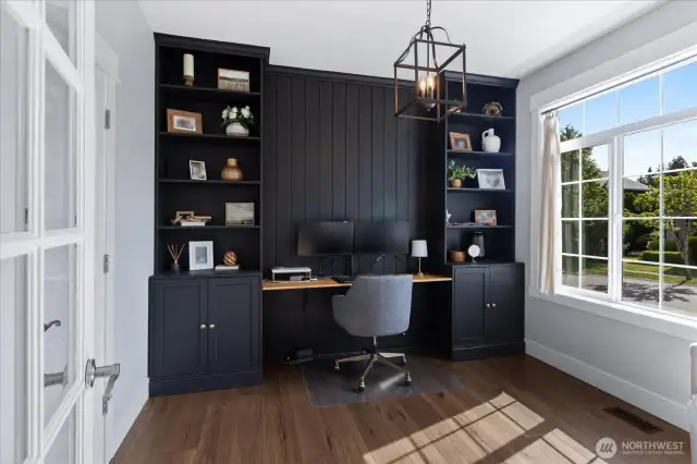 Custom black cabinet and shelf combo with wood desk and dramatic beadboard. WOW! What a dream home office  complete with a glass french door for privacy and peering in.