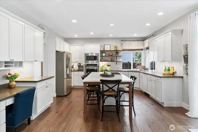 Here's a show-stopper kitchen for ya! XL quartz island with seating for 5! Home Command Center on the left for the organizing and ordering that needs to be done in a home of this size. Big and Beautiful best describe this kitchen.