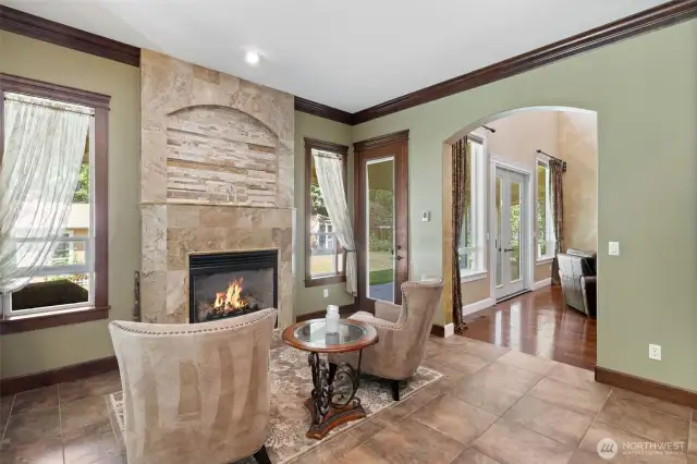 Sitting area with gas fireplace right off the kitchen eating area. Windows letting in the light and extending you into the magnifcent yard.  You can just picture yourself enjoying your drink of choice.