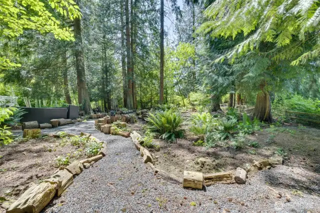 This soothing walk through the natural pathway, with many new plants to enjoy, was once all bushes, stickers and such.  Owners did a great job in making it a private oasis!