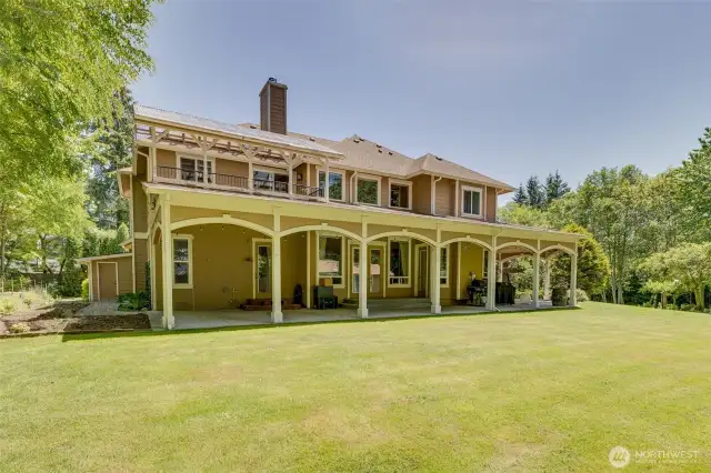 Look at this Wrap around covered patio! Sitting areas, BBQs, and the house still takes in the natural light!