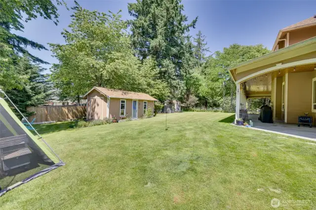 Outdoor, upgraded shed with your Riding Lawn Mower that stays complimentary!  A fire pit near by.  Chicken Coop and Hen house to the right of the Shed!  No HOA!!