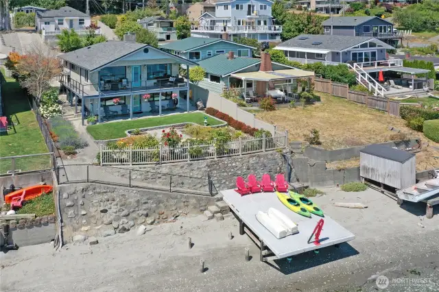 Main Beach House, waterside dock, sandy beach, and Guest Cottage behind the Main House