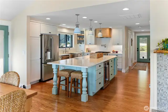 Kitchen view from dining room to entry. breakfast bar, quartz counter tops, plenty of cabinet space, Eucalyptus floors...