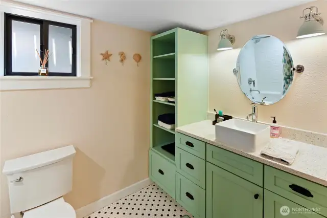 Lower level full bath with soaking tub and tile floor.