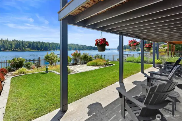 The ground floor covered patio has a great outlook over the gardens to the view.