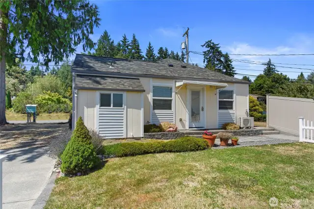 The Guest Cottage has it's own street address and separate utilities except for sewer and water. By the white picket fence is a concrete sidewalk along the fence to the rose garden and beach access.