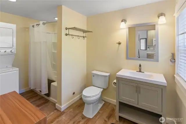 The bath and laundry room is spacious. An exterior closet is behind the shower for storage and hot water tank.