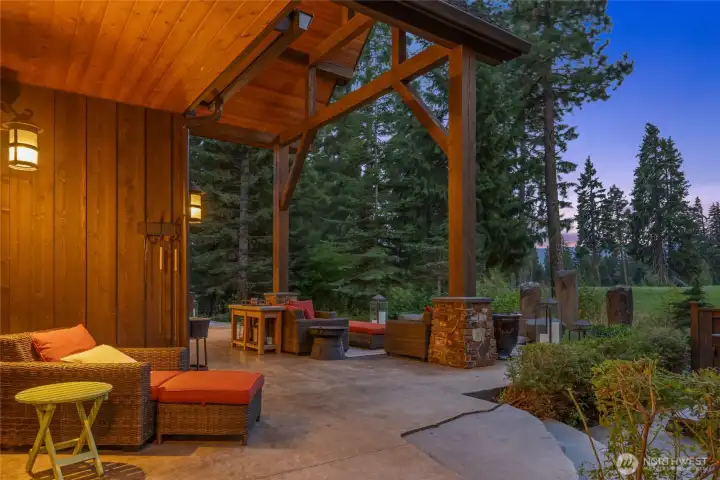 Step outside primary bedroom to covered patio and hot tub area