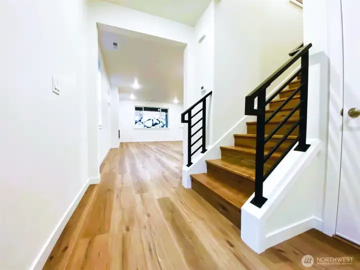 LVP flooring on main level with open stair rail
